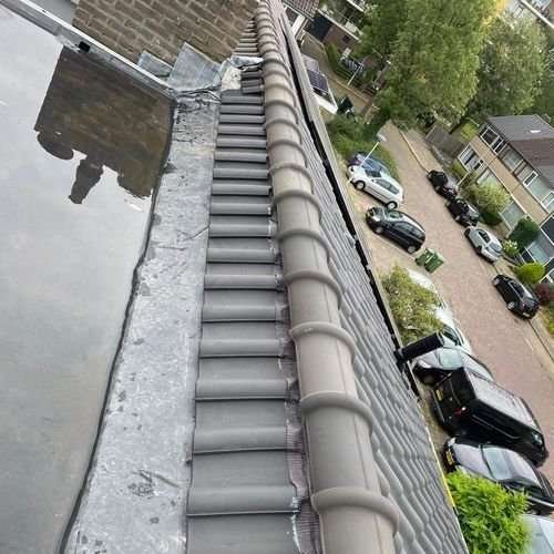 Dakpannen met zonnepanelen en kilgoot